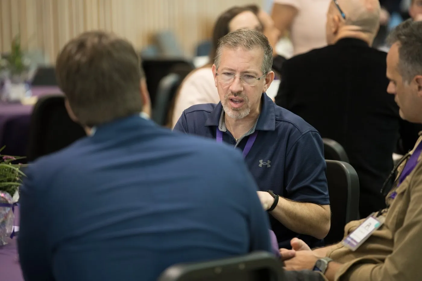 Two founders in commercial discussion across a table